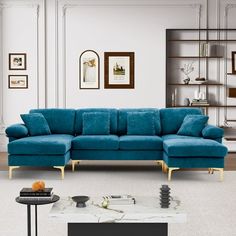 a living room with blue couches and pictures on the wall