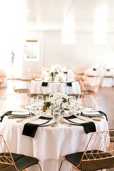 the tables are set with white and black linens