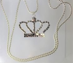 Gold or Silver Jewel Encrusted Crown Pendant, These crown necklaces are perfect for all royalty with all their rhinestones. They would make an exceptional gift for a fashionista. They are exquisite and would make an excellent charm or just as a collectible for the designer at heart. The are about 1.5 in x 2 in and they come with a 28" chain. Rhinestone Pendant Necklace For Parties, Metal Rhinestone Pendant Necklace For Parties, Party Rhinestone Pendant Necklace, Metal Rhinestone Necklace For Gift, Metal Necklace With Rhinestones For Gifts, Metal Necklaces With Rhinestones For Gifts, Dainty Metal Necklace With Rhinestones For Gift, Metal Rhinestone Pendant Necklace, Party Pendant Rhinestone Necklace With Bling