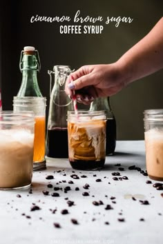 someone is filling coffee syrup into jars