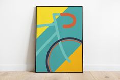 a poster with a bicycle on it in front of a white wall and wooden floor