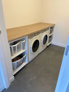 a washer and dryer sitting in a room next to each other on the floor