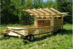 a wooden trailer with a canopy attached to it