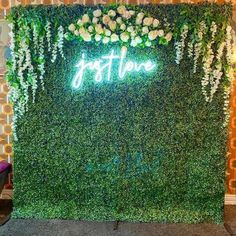 a green wall with white flowers and the word arthouse on it's side