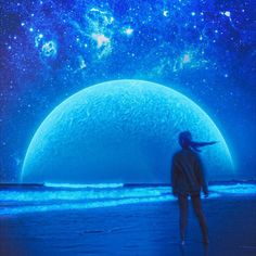 a person standing in front of a giant blue ball on the beach with stars above it