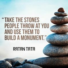 some rocks stacked on top of each other with a quote