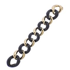 Brand new Seaman Schepps large link bracelet in 18k gold with ebony wood. Comes with box. DESIGNER: Seaman Schepps MATERIAL: 18k Gold GEMSTONES: Wood DIMENSIONS: Bracelet is 7.75" long end to end, wearable length is approx. 7. - 7.25", width 33mm. MARKED/TESTED: 750, 242373 Z, Shell hallmark, Seaman Schepps. WEIGHT: 76.4 grams CONDITION: Brand New Classic Black Chain Bracelet For Formal Occasions, Black Link Jewelry For Formal Occasions, Modern Black Chain Bracelet For Formal Occasions, Elegant Black Link Jewelry, Elegant Black Chain Bracelet For Formal Occasions, Classic Black Jewelry With Gold Chain, Elegant Black Chain Bracelets, Elegant Black Chain Bracelet, Black Polished Finish Bracelet For Formal Occasions