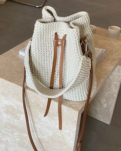 a white purse sitting on top of a table