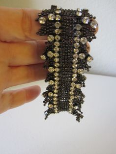 SWAROVSKI STRETCH BRACELET This bracelet is simply elegant! Made of a zillion tiny steel gray beads and gorgeous sparkling prong set rhinestones. 7 inch bracelet with some stretch. It feels like lace fringe. So perfect for any dressy occasion. In excellent vintage condition! Would make a beautiful gift. Elegant Beaded Stretch Bracelet For Parties, Elegant Beaded Bracelets With Sparkling Stones For Party, Elegant Rhinestone Stretch Bracelet For Party, Party Stretch Bracelet With Rhinestones, Elegant Beaded Bling Bracelets For Party, Elegant Silver Stretch Bracelet With Bling, Crystal Beaded Bracelets With Rhinestones For Party, Silver Beaded Bracelets With Sparkling Stones For Party, Silver Sparkling Beaded Bracelets For Party