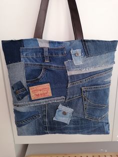 a bag made out of old jeans hanging on a wall