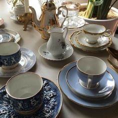 a table topped with lots of blue and white china