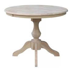 a round wooden table sitting on top of a white floor