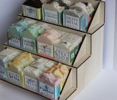 three tiered display case with soaps on it