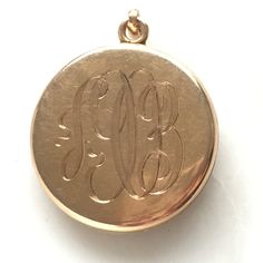 "Details: Absolutely beautiful Art Nouveau Locket with a lovely woman's face surrounded by roses. The piece is in amazing condition and we have kept the original photos in place. They would be easy to pull out and replace with new. Please ask all necessary questions prior to placing an order! Measurements: The locket measures 1\" inch round, and is 4mm thick. The weight of the piece is 9 grams. Condition: This piece is in very good condition." Ornate Engraved Brass Locket Necklace, Vintage Bronze Locket Necklace In Brass, Ornate Brass Locket Jewelry, Ornate Bronze Locket Necklace In Brass, Art Nouveau Locket, Locket Pendant Necklace, Gold Locket, Pocket Watch, Locket