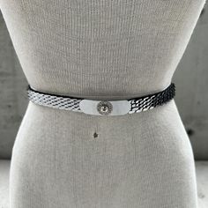 Vintage 70s silver tone stretch belt, silver metal fish scale cincher, floral buckle, statement belt, thin sophisticated waistband Indulge in the timeless allure of the Vintage 70s Silver Tone Stretch Belt--an exquisite fusion of vintage charm and statement-making elegance. The silver metal fish scale cincher, meticulously designed, envelopes your waist in a breathtaking dance of metallic textures, creating an enchanting visual feast. The thin and sophisticated waistband offers a sleek silhouette, epitomizing the refined minimalism of the era. The pièce de résistance is the rectangular silver tone buckle, featuring a captivating mirror effect and adorned with a delicate flower at its center. This intricately detailed focal point elevates the belt to new heights of sophistication, capturing 70s Glamour, Statement Belt, Metal Fish, Fish Scale, Stretch Belt, Fish Scales, Delicate Flower, Vintage Charms, Vintage 70s