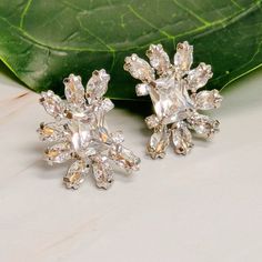 Discover the perfect blend of elegance and versatility with our Shine Crusted Jewel Stud Earrings. Adorned with stunning jewels, these earrings add a touch of glamour to any outfit. Dress them up or down for a statement look. Get ready to shine with style.Dimensions: Approximately 0.7" x 1"Made In: China Material Composition: Rhodium plated brass, glass stones, Lead and Nickel free Exclusive Clothing, Outfit Dress, To Shine, Silver Earrings Studs, Hat Hairstyles, Get Ready, Rhodium Plated, Clothes For Sale, Composition