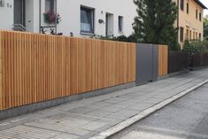 a wooden fence on the side of a street