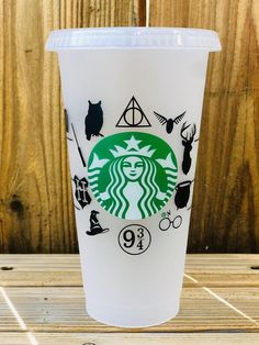 a starbucks cup with harry potter symbols on it