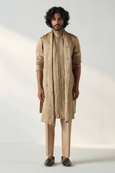 Khaki gold kurta featuring dori, mirror embroidery on the cuffs, collar and on front panel. Paired with chanderi straight pant and a mirror embroidered stole. - Aza Fashions Festival Cotton Silk Bandhgala With Gota Work, Festive Bandhgala With Gota Work For Eid, Festive Cotton Silk Kurta With Dabka Work, Festive Raw Silk Sherwani With Gota Work, Festive Sherwani With Gota Work For Eid, Unstitched Gota Work Bandhgala For Diwali, Eid Festive Sherwani With Gota Work, Festive Slub Silk Kurta With Chikankari Embroidery, Festive Kurta With Gota Work For Eid