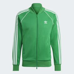 A TRACK JACKET MADE IN PART WITH A BLEND OF RECYCLED AND RENEWABLE MATERIALS. Adidas Long Sleeve Track Jacket With Three Stripes, Adidas Three Stripes Outerwear For Sports Events, Adidas Outerwear With Three Stripes For Sports Events, Adidas Sportswear For Sports Events, Green Athleisure Outerwear With Ribbed Cuffs, Adidas Sportswear Track Jacket With Three Stripes, Sporty Green Track Jacket With Ribbed Cuffs, Green Sporty Track Jacket With Ribbed Cuffs, Three Stripes Track Jacket For Sports Events