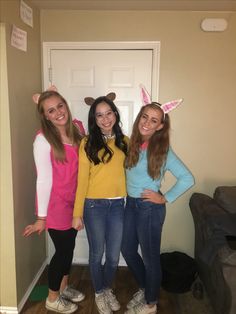 three girls in bunny ears are posing for the camera