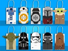 star wars gift bags hanging from strings on a blue background, with the faces of various characters