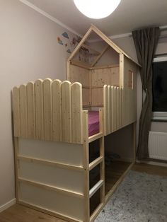 there is a bunk bed with a house shaped roof on the top and stairs to the bottom