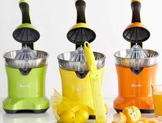 three juicers are lined up next to each other