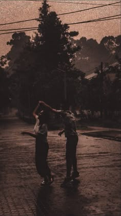 two people standing in the rain with an umbrella