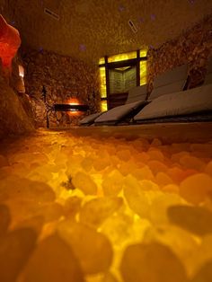 a bed room with some lights on and rocks in the floor next to each other