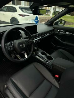 the interior of a car with black leather seats