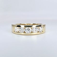 a yellow gold wedding band with five diamonds