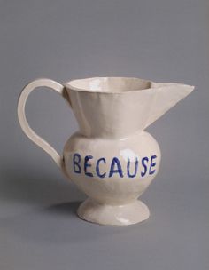 a white pitcher with blue writing on the bottom that says because it's not water