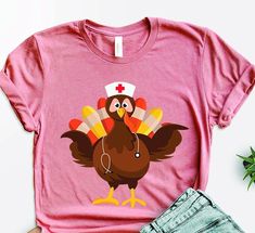 Nurse Turkey Thanksgiving T-shirt, Funny Nurse Turkey T-shirt, Thanksgiving Nurse Shirt, Thanksgiving Gift For Nurse, Nurse Appreciation Tee Hello Valued Customer, We're excited to present to you our fantastic range of shirts! Our goal is to bring joy to everyone through our charming, fashionable, and up-to-date graphic T-shirts. Whether you're treating yourself or someone special, our shirts are sure to bring a smile. 👕🌟 Our designs are tailored for various colors: Black designs are ideal for White, Yellow, Athletic Heather, Orange, Pink, Baby Blue, Mint, Natural, Desert Pink, Banana Cream, Cancun, and Heather Peach. For all other colors, White designs are recommended. All our products are premium quality, proudly printed in the USA. Hey there! Welcome to our store! We're delighted to h Funny Cotton T-shirt With Heat Transfer Vinyl, Desert Pink, Pink Banana, Black Designs, Nurse Stuff, Funny Nurse, Turkey Thanksgiving, Gift For Nurse, Nurse Appreciation