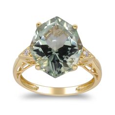 a ring with an aqua green and white topazte stone in the center, surrounded by diamonds