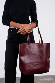 Our lifetime favorite and consistent bestseller, the Mamuye Classic Tote is the perfect everyday tote. Crafted with the highest quality, this bag is made to stand the test of time. Handcrafted in both Ethiopia and Mexico 100% distressed leather Tote measures 14" H x 16" W x 6" D Comfortable, durable straps (straps have a 10.5" drop) Interior pocket Subtle variations add to the uniqueness of each product This product is named after one of the heroic women we work with. Heroic Women, Wrap Jacket, Everyday Tote, Western Boho, The Test, Distressed Leather, Tote Purse, 6 D, Leather Care