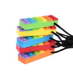 three legos are stacked on top of each other with black string attached to them