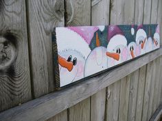 three ducks painted on the side of a wooden fence