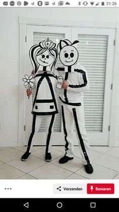 two people in costumes standing next to each other with one holding a paper cutout