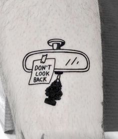 a man's arm with a black and white drawing of a bathroom scale on it that says, don't look back