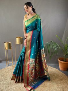 Wear this gorgeous teal blue paithani silk saree and let its beauty graciously capture your soul. Crafted with intricate zari weaving work and an elegant rich pallu adorned with golden motifs all over, this saree exudes timeless elegance and sophistication.
Made from high-quality silk material, this traditional saree showcases a stunning teal blue color, which adds a touch of poise and grace to your overall look. The silk fabric blouse that comes with the saree features similar zari weaving work Navy Blue Saree, Blue Silk Saree, Bridesmaid Saree, Paithani Saree, Teal Blue Color, Traditional Saree, Blue Saree, Saree Trends, Peacock Green