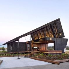 a modern house with an unusual roof structure