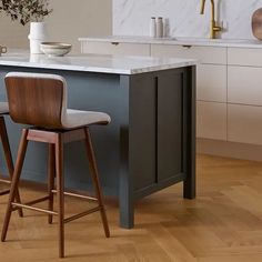 two bar stools in front of a kitchen island