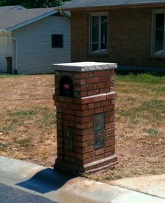 a brick mailbox in front of a house