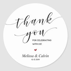 thank you for celebrating with us sticker on a round white paper circle, with the words'thank you for celebrating with us'written in black ink