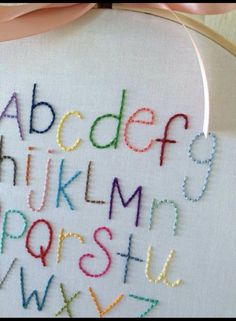 a cross stitched alphabet is shown in the hoop