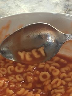 a spoon with some food in it and the word yes is spelled by letters that spell out