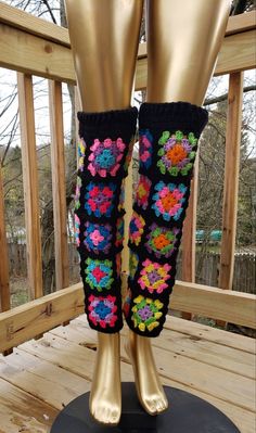 the legs of a mannequin are decorated with crocheted flowers