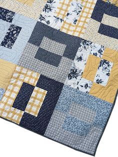 a blue and yellow patchwork quilt on a white background