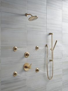 the shower head and handset are connected to the wall in this modern style bathroom